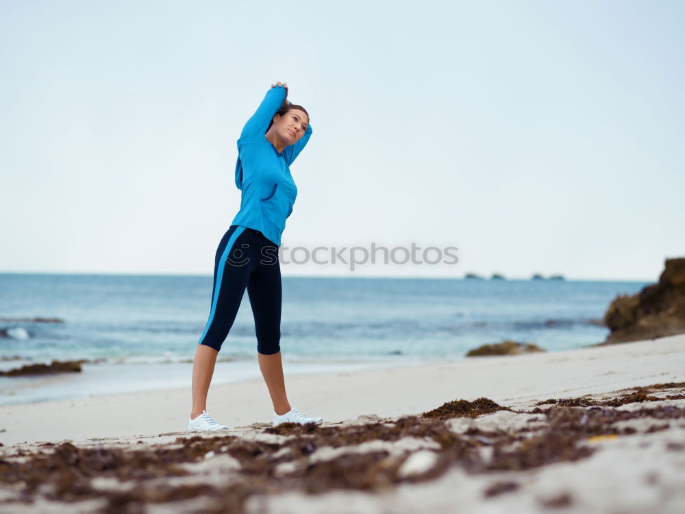 Similar – Fit female athlete drinking water after workout on beach