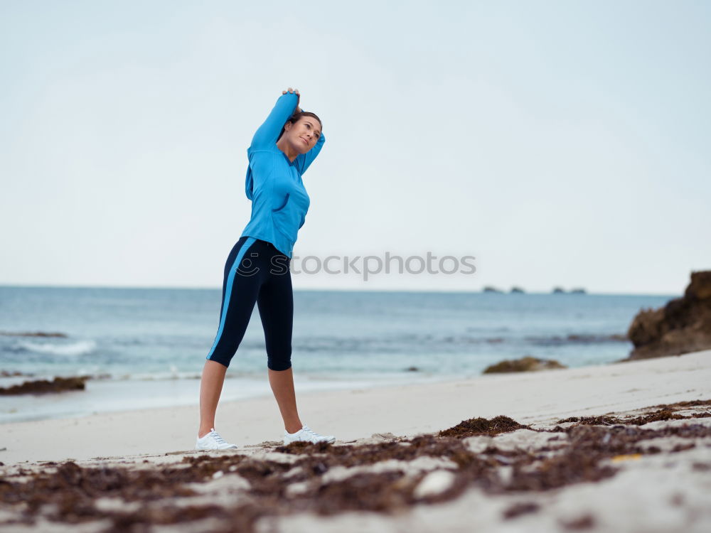 Similar – Fit female athlete drinking water after workout on beach