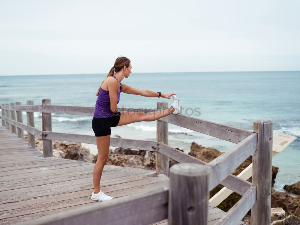 Similar – Adult fitness couple doing exercise together on beach