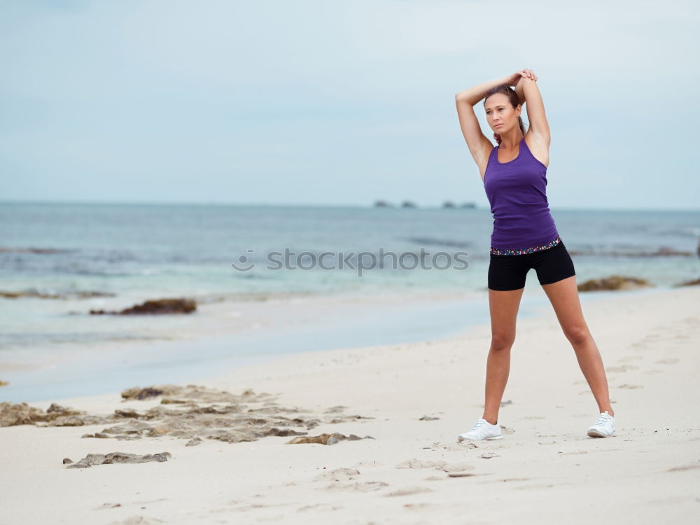 Similar – Fit female athlete drinking water after workout on beach