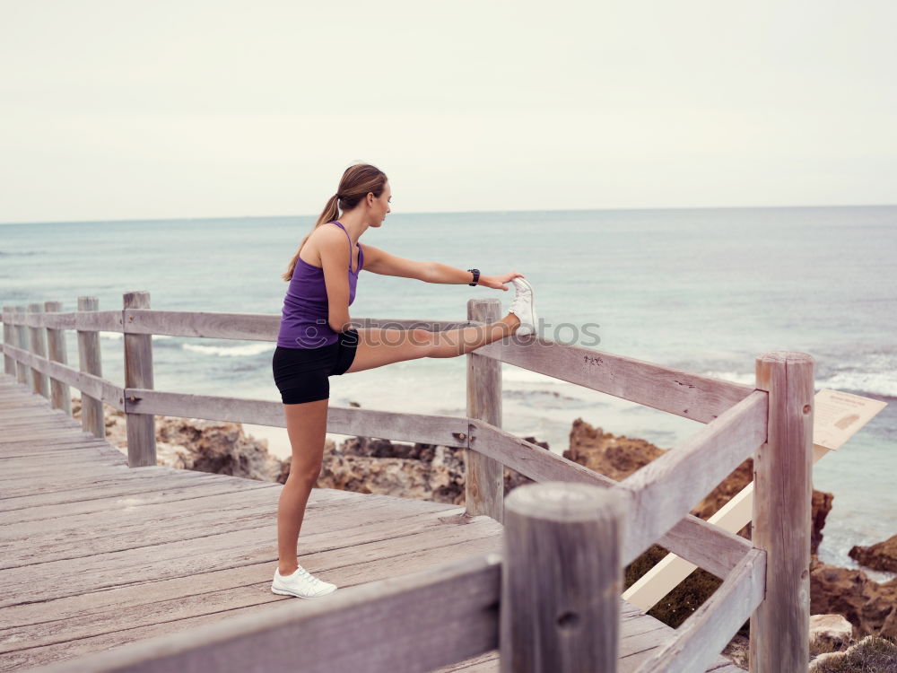 Adult fitness couple doing exercise together on beach