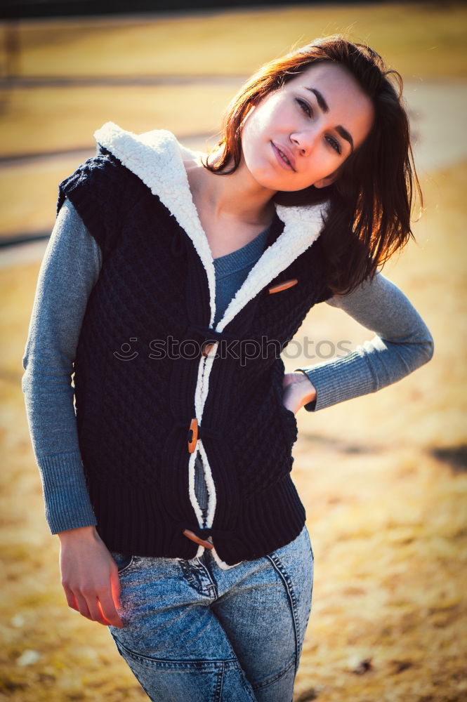 Similar – Stylish smiling teenager sitting on the ground in a city park