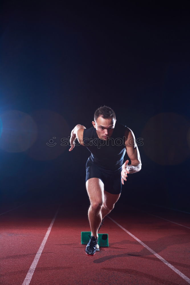 Sportsman stretching legs on stadium