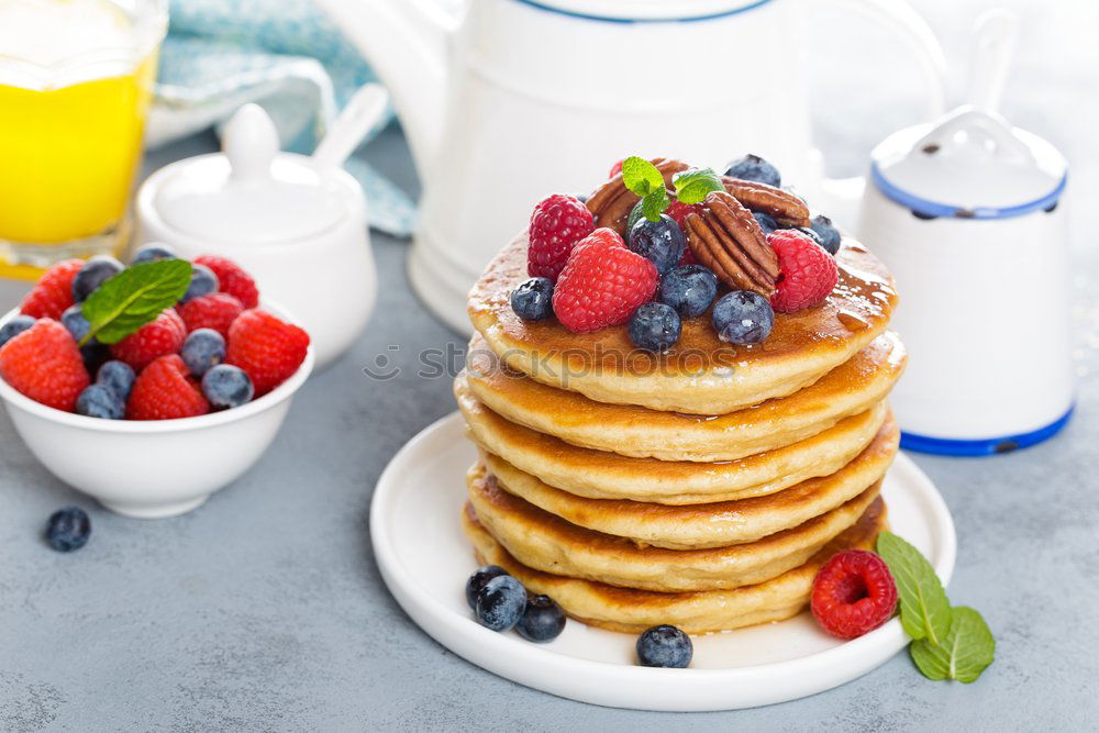 Similar – Image, Stock Photo Pouring honey in pancakes with raspberries and blueberries