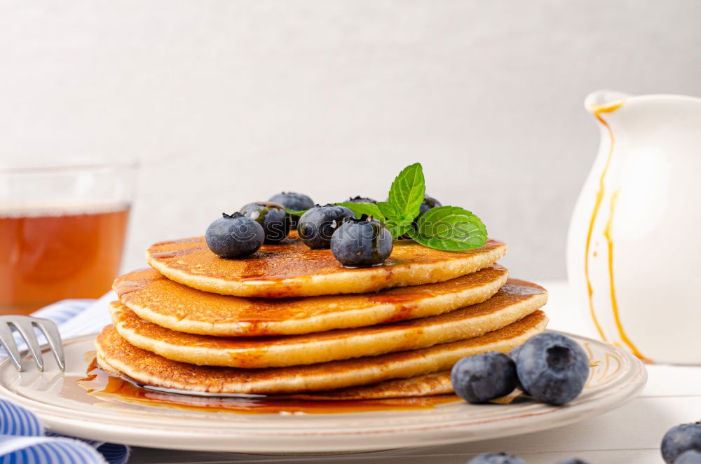 Similar – Image, Stock Photo Pouring honey in pancakes with raspberries and blueberries