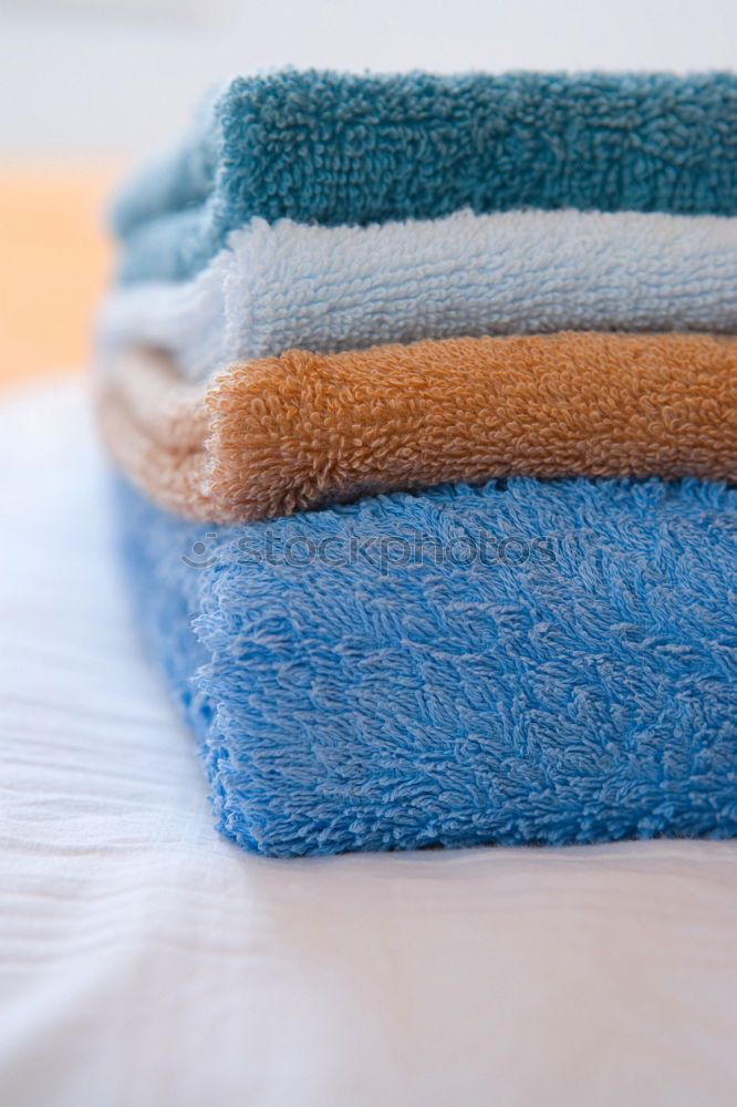 Similar – colourful washcloths hang in a row from the heating in the bathroom