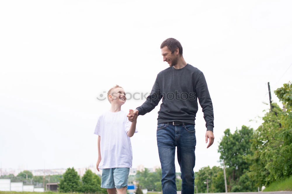 Father and son playing on the road at the day time.