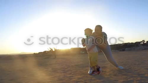 Similar – Image, Stock Photo Blonde woman and bearded man taking a walk embraced outdoors at sunset.