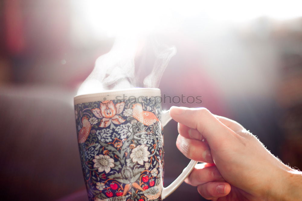 Young woman with steaming cup