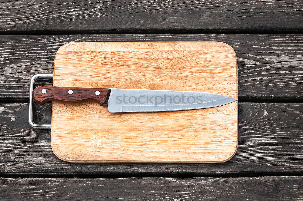 Similar – Old hatchet an a wooden cutting board, top view