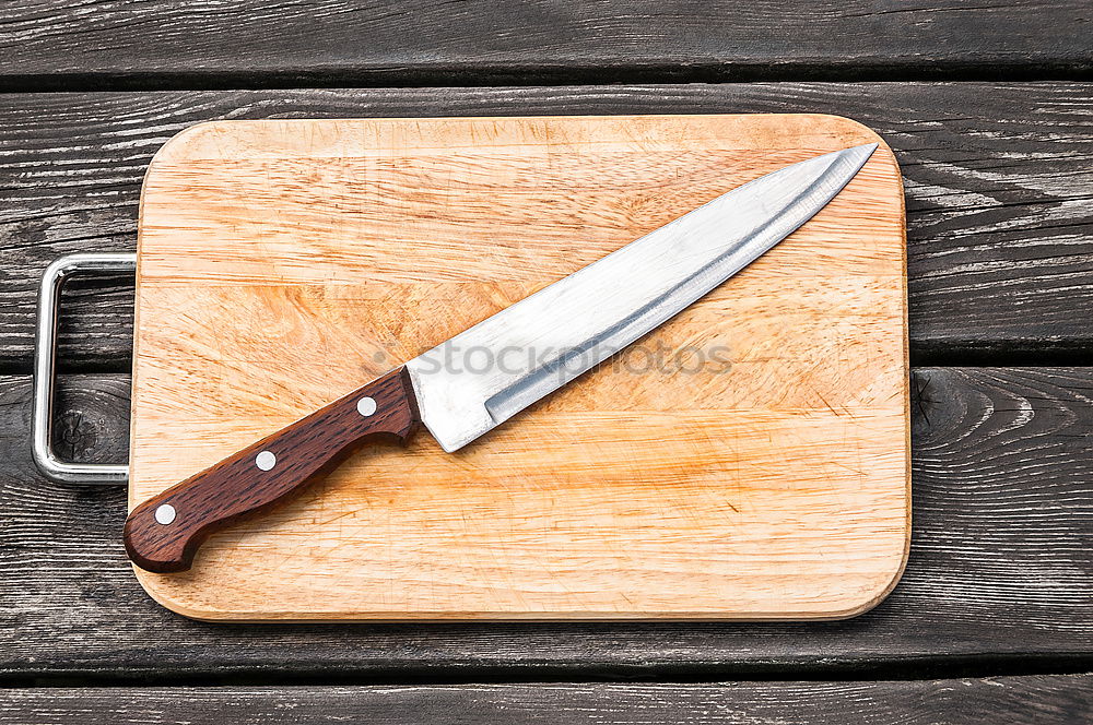 Similar – Old hatchet an a wooden cutting board, top view