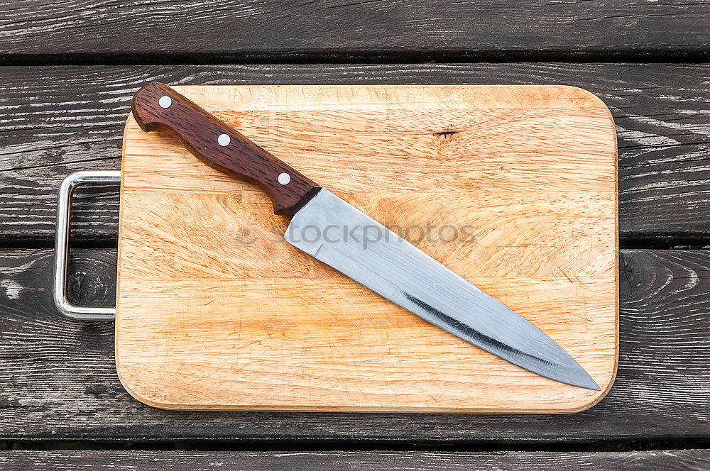 Similar – Old hatchet an a wooden cutting board, top view