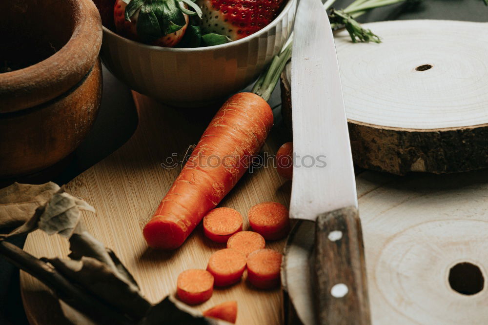 brown cutting board with a knife