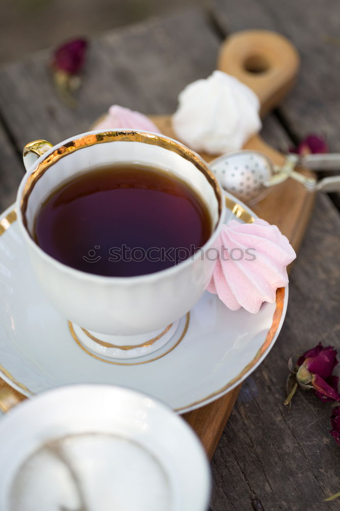 Similar – Black tea in a white cup and saucer and jasmine flowers