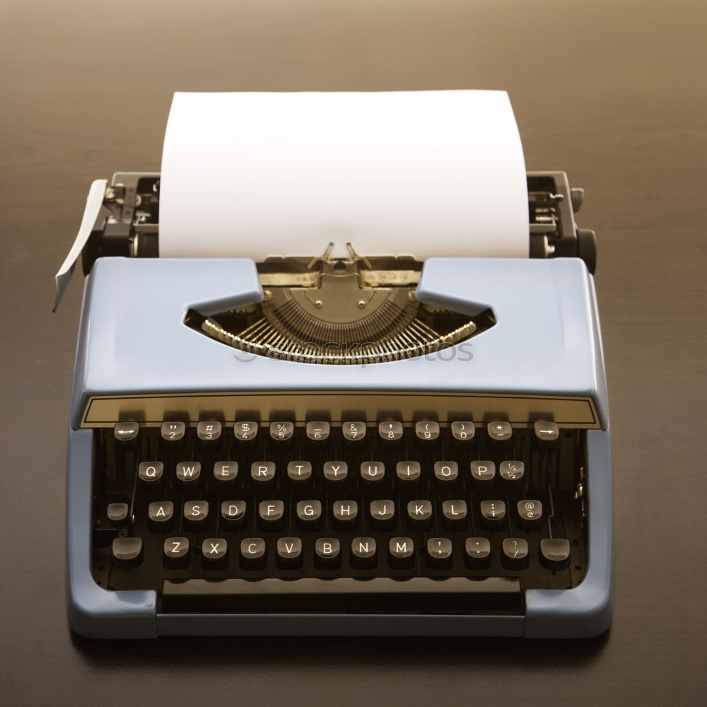 Red vintage typewriter with blank paper sheet on table