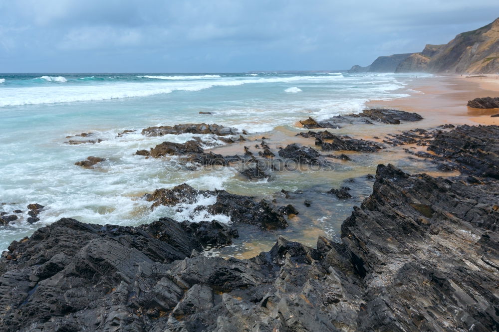 Similar – Beach landscape with cliffs