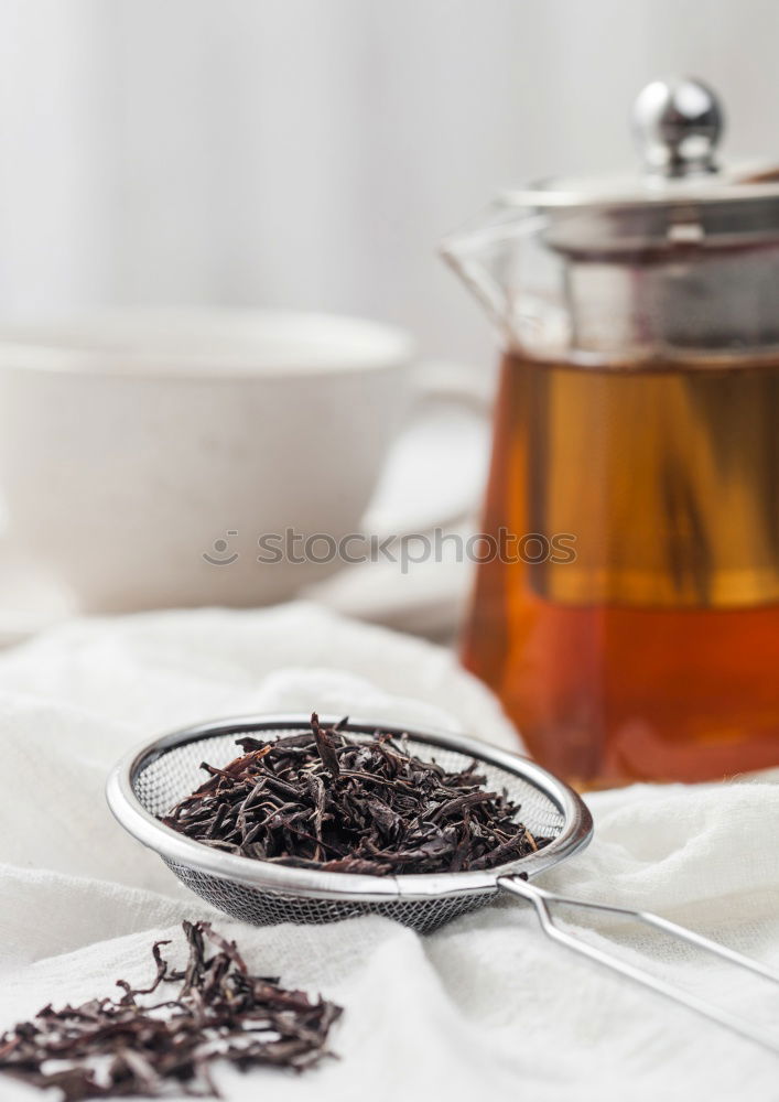 Similar – Black tea with jasmine in a white cup on a brown wooden table