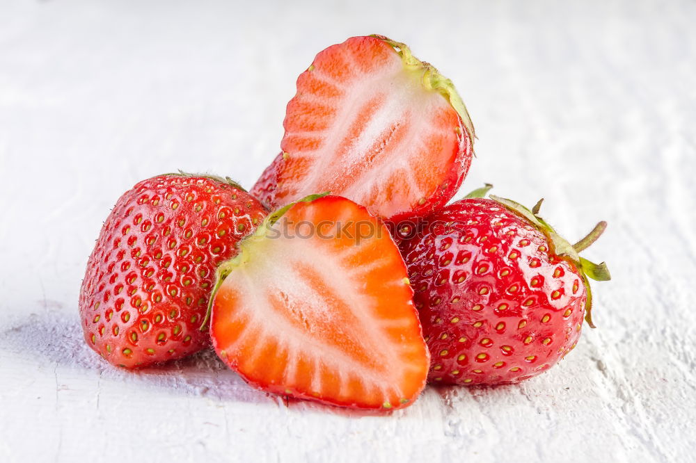 Similar – Strawberries whole and cut on a white wooden table