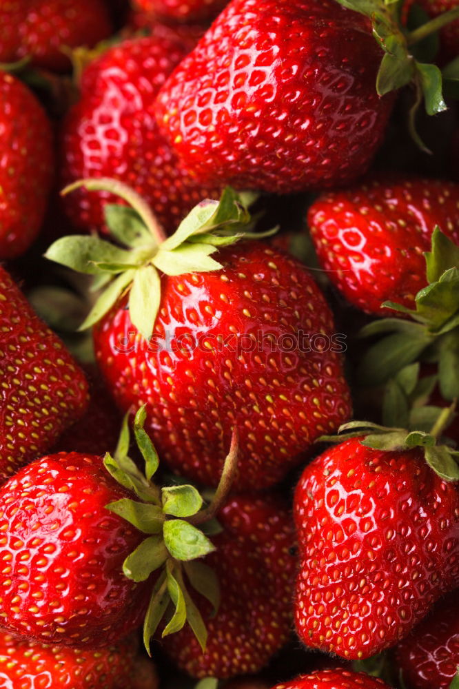 Similar – red strawberries with green stems in sale trays