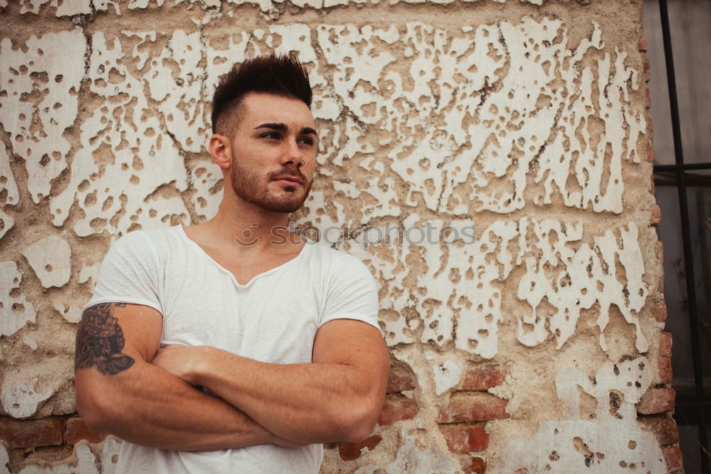 Similar – young handsome man with t-shirt against a wall in street