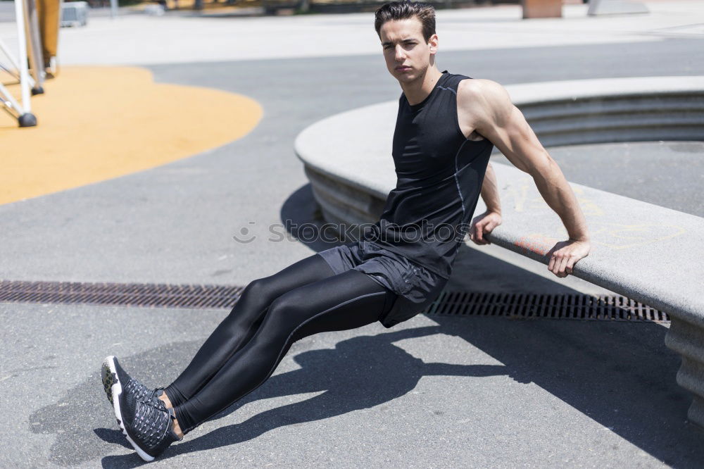 Muscular man stretching outdoors