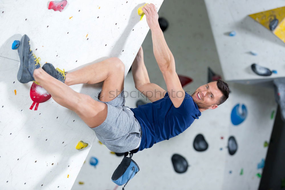 Similar – A Man practicing rock climbing on artificial wall indoors