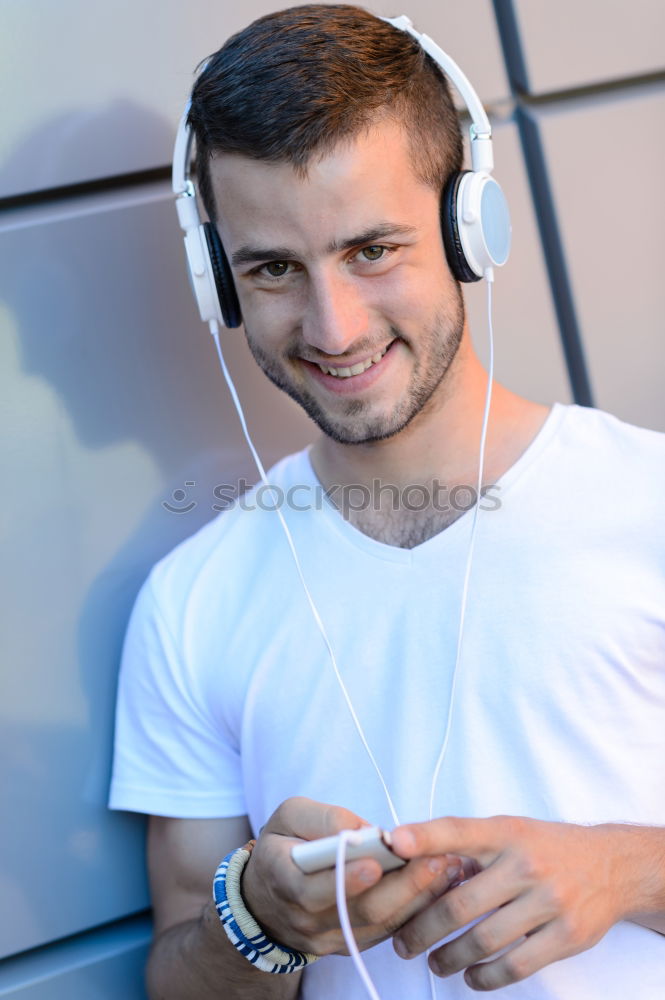 Similar – Portrait of relaxed young boy sitting at the patio door and listening to music from mobile phone