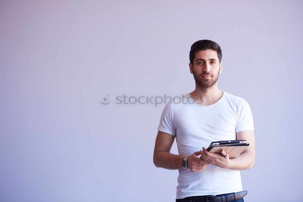 Similar – Young bearded man in urban background wearing casual clothes while leaning on a wall and looking at camera