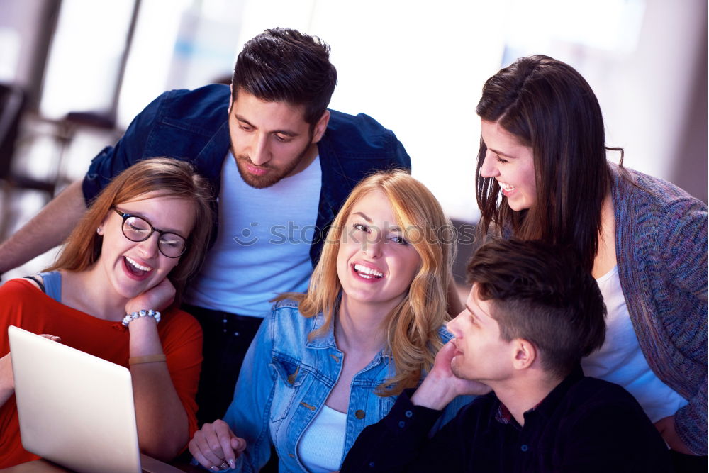 Similar – Image, Stock Photo Multi-ethnic group of young people looking at a tablet computer outdoors