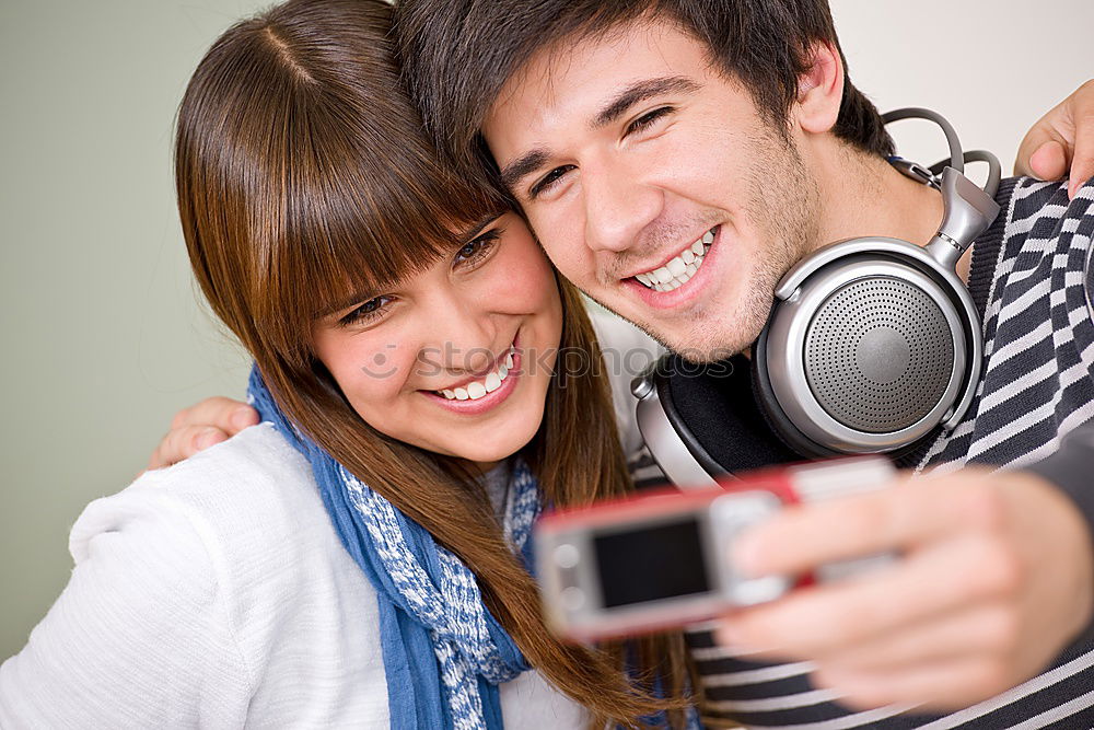 Similar – Image, Stock Photo Top shot of brother and sister listening to music together from smartphones