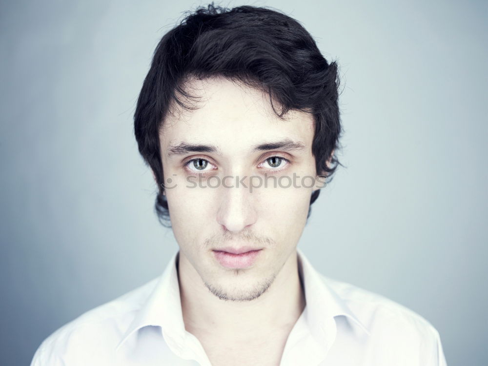 Similar – Boy with a white T-shirt in front of a dark wall