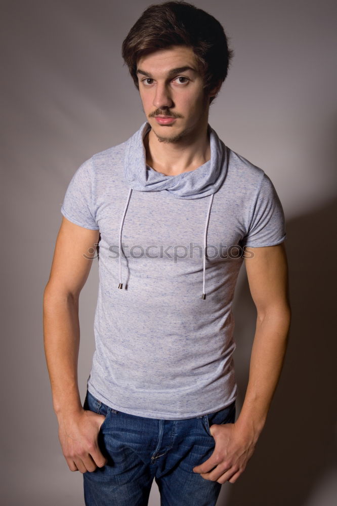 Similar – Young man standing in urban background with modern hairstyle.