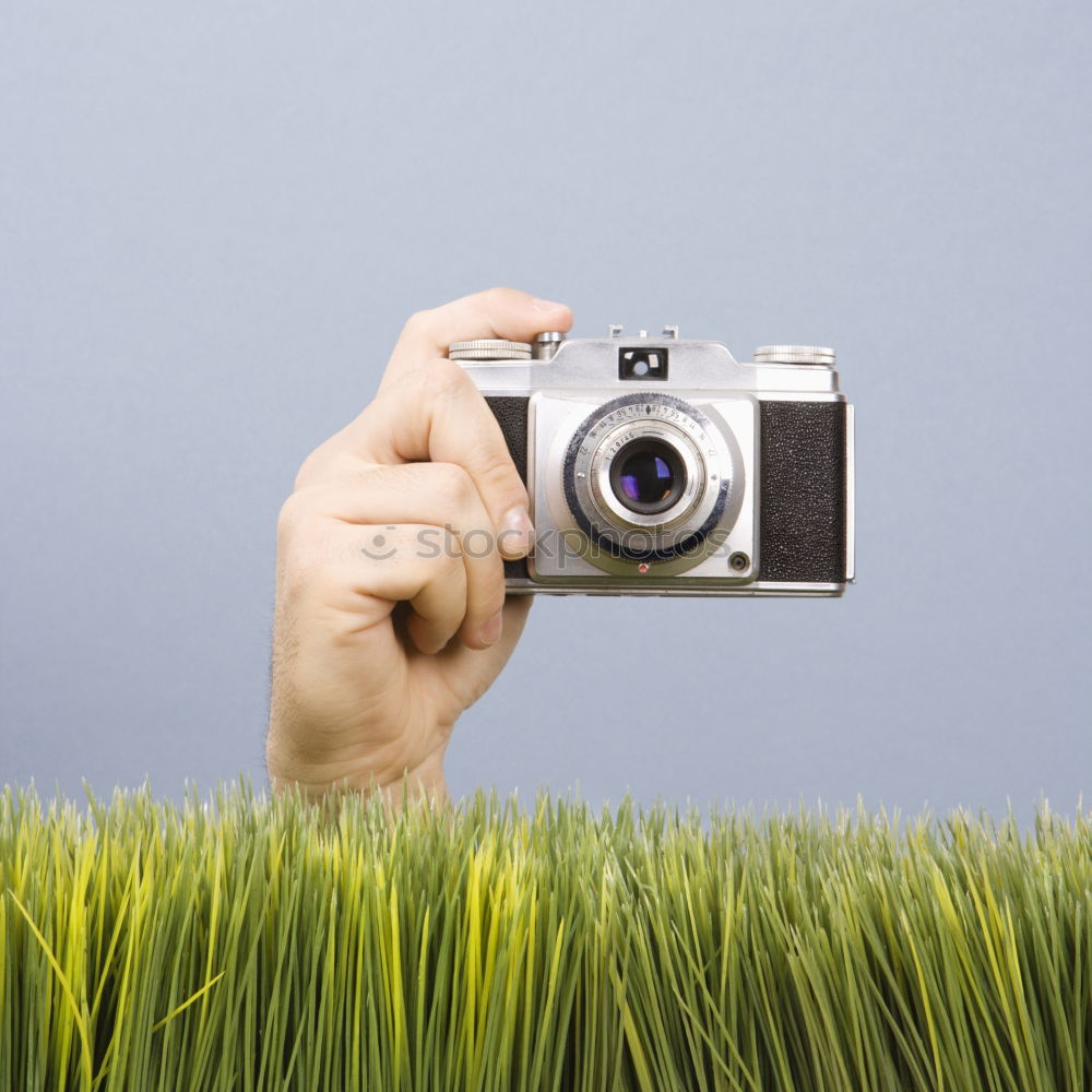 Similar – analogue 35mm camera on brown wooden table