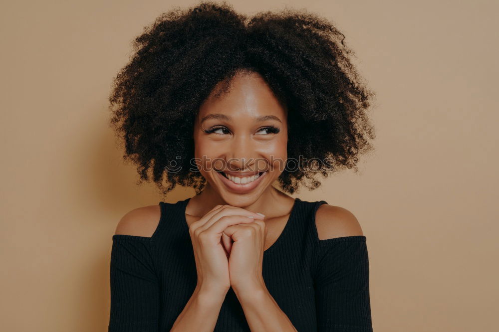 Similar – close up of a pretty black woman with curly hair smiling and lying on bed looking at the camera