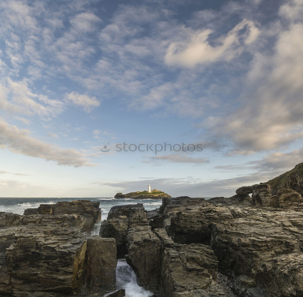 Similar – A lot of rocks with a small lighthouse