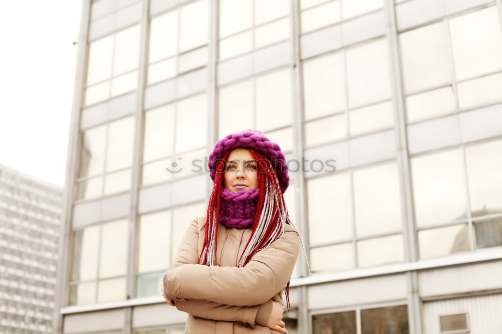 woman with pink hair at run-down housing estate