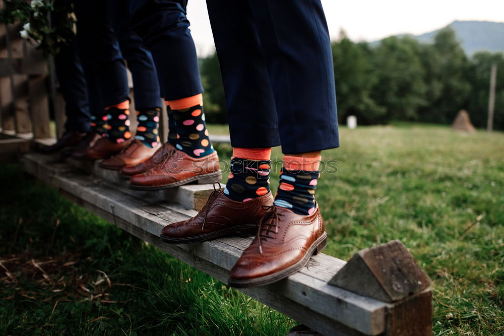 stylish men’s socks. Stylish suitcase, men’s legs, multicolored socks and new shoes. Concept of style, fashion, beauty and vacation