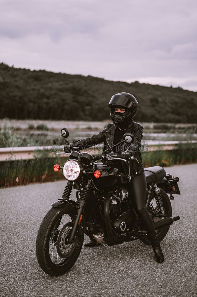 Similar – Man standing near motorcycle