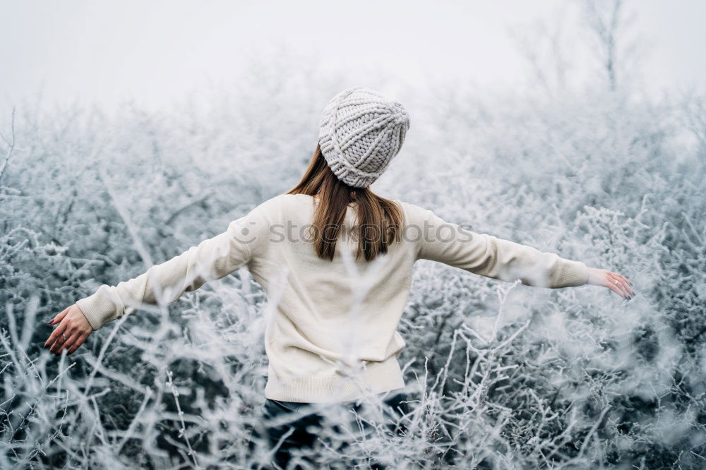 Similar – young hooded woman in a white sweatshirt with a serious look