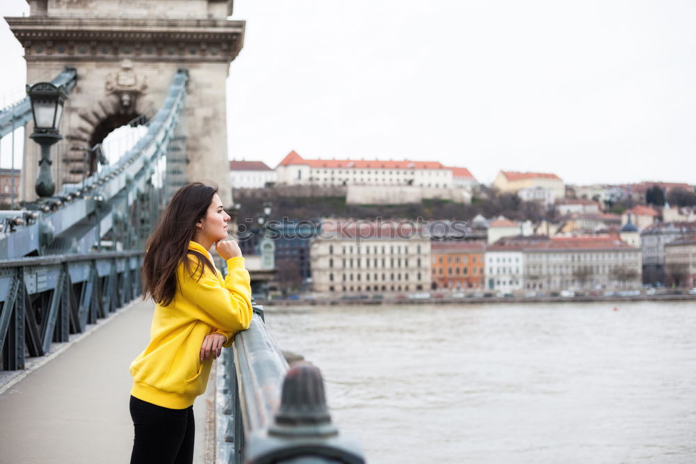 Similar – Stylish woman sitting near bridge in old city