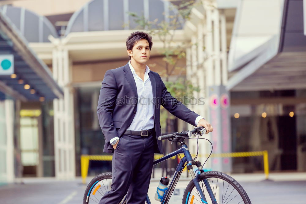 Similar – Man in the street wearing suit near a vintage bicycle.