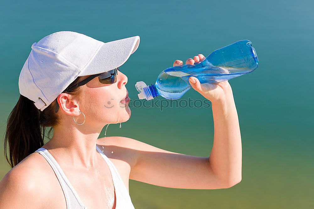 Similar – Fit sporty woman drinking water from a bottle