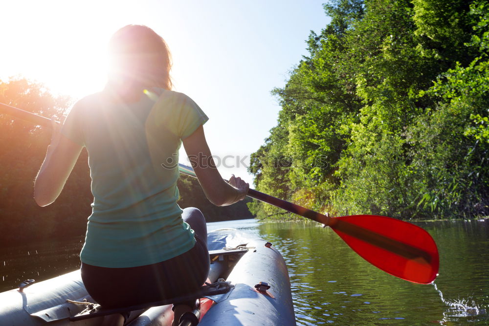 Unrecognizable woman on kayak exploring river