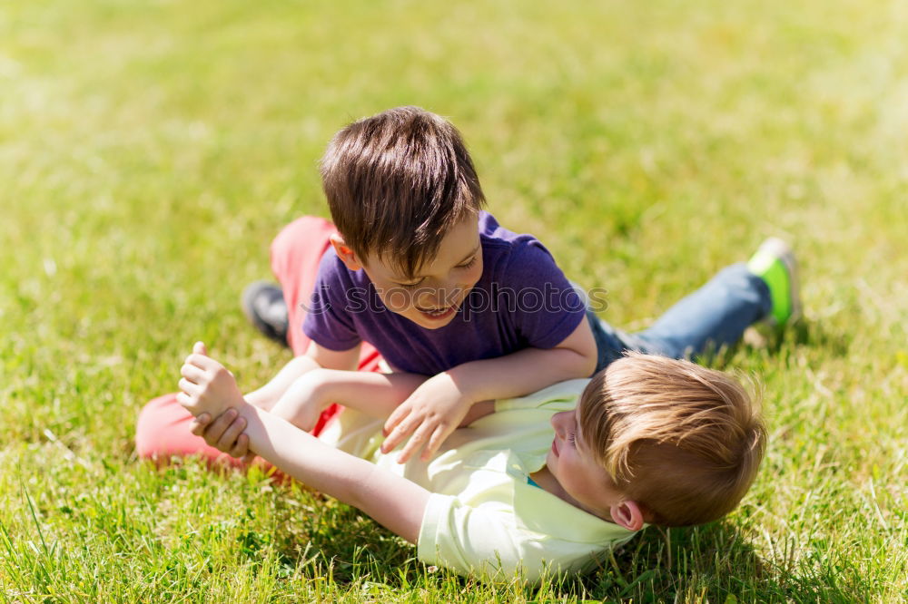 Similar – Two happy children playing near a tree on the grass