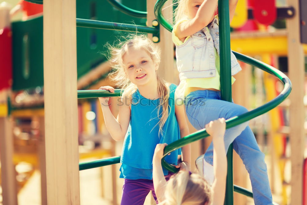 Similar – Cute caucasian siblings sitting on slide on playground