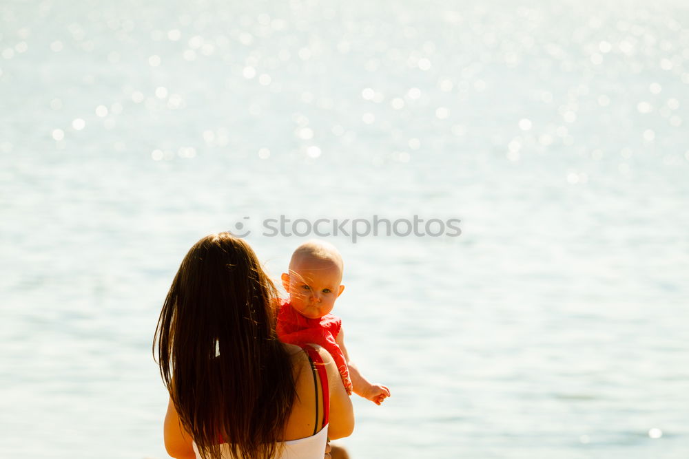 Similar – Image, Stock Photo caucasian mother and son playing with windmill at the beach