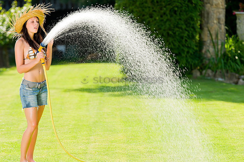 Similar – Teen girl spraying little sister in garden