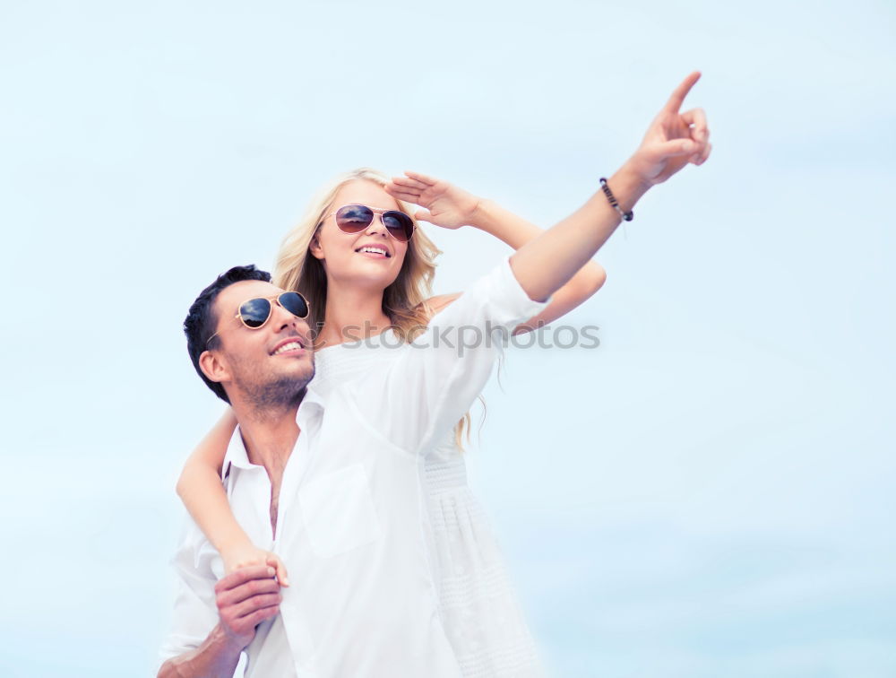 Similar – Happy young man and woman in fashionable sunglasses taking cellphone selfie on background of defocused blue sea. Vacation photos