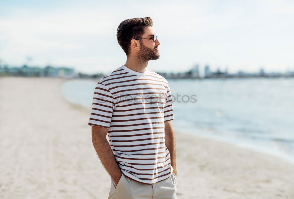 Man with skateboard at beach