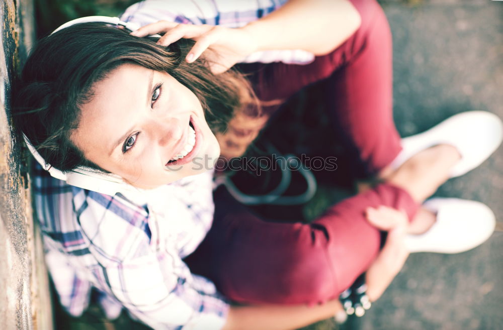 Similar – Young woman sitting leaning against a wall in the shade